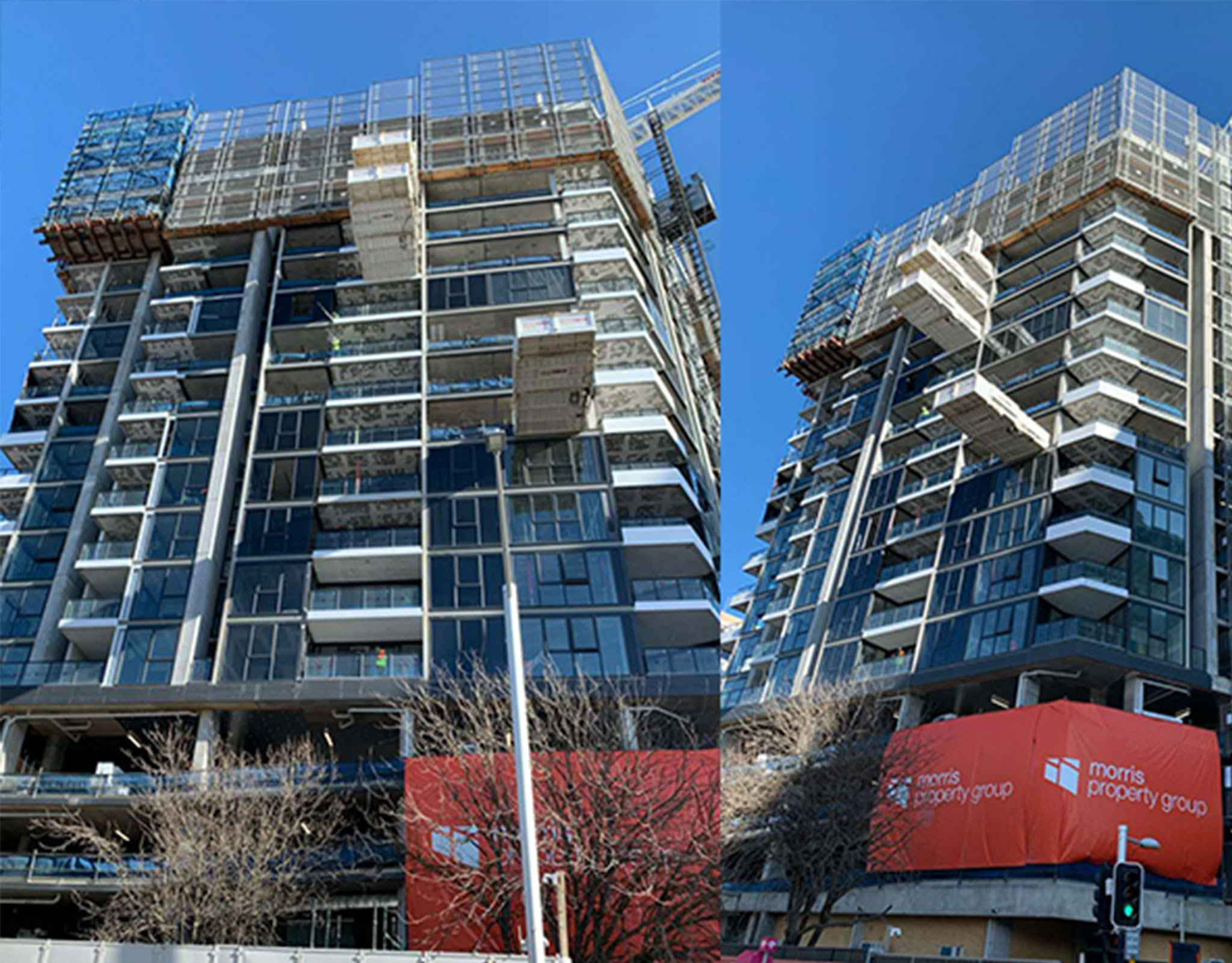 Two completed glass residential towers photographed from an adjacent intersection