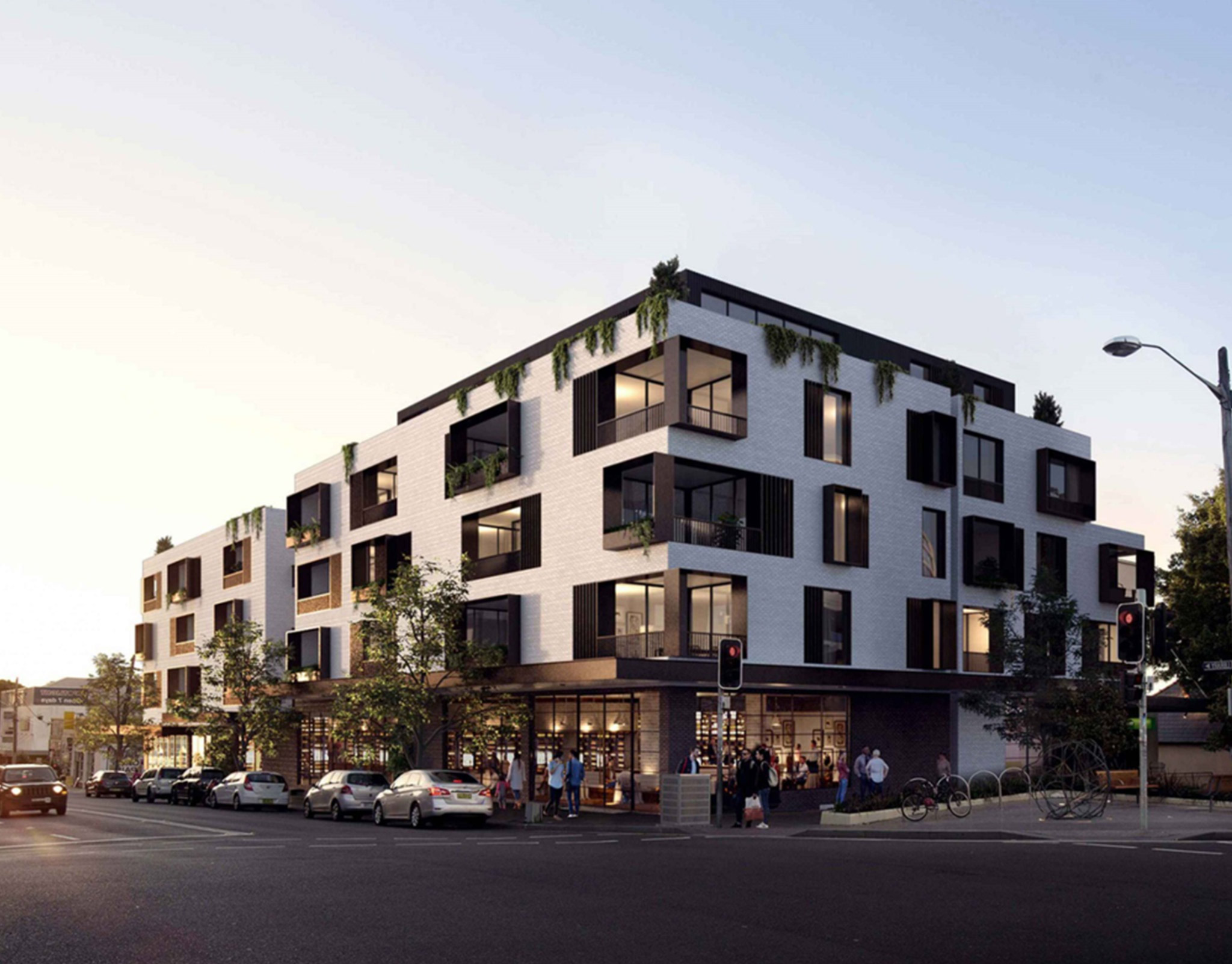 Rendering of a black and white corner mixed-use building with ground-floor retail and deep window reveals
