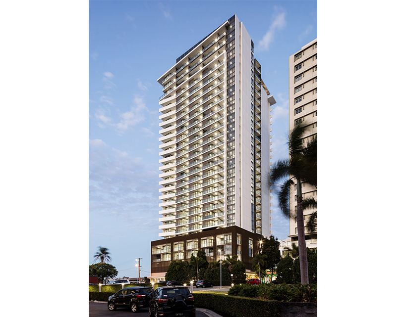 Rendering of a tall residential tower behind palms with a glazed street-level base